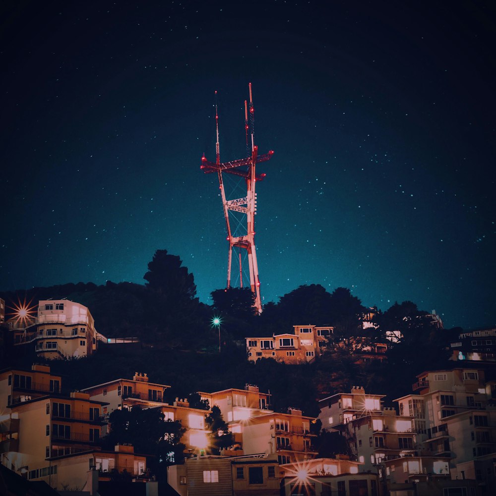 red and white signal tower at night