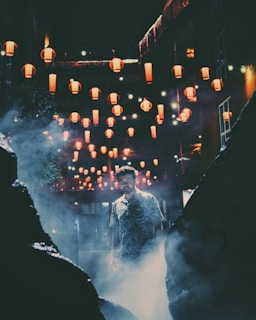An atmospheric shot of the film’s main location at dusk, with lanterns glowing softly in the plaza.