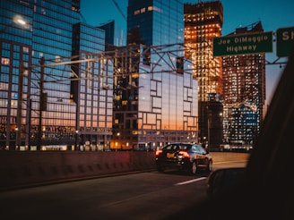 car passing through road beside building