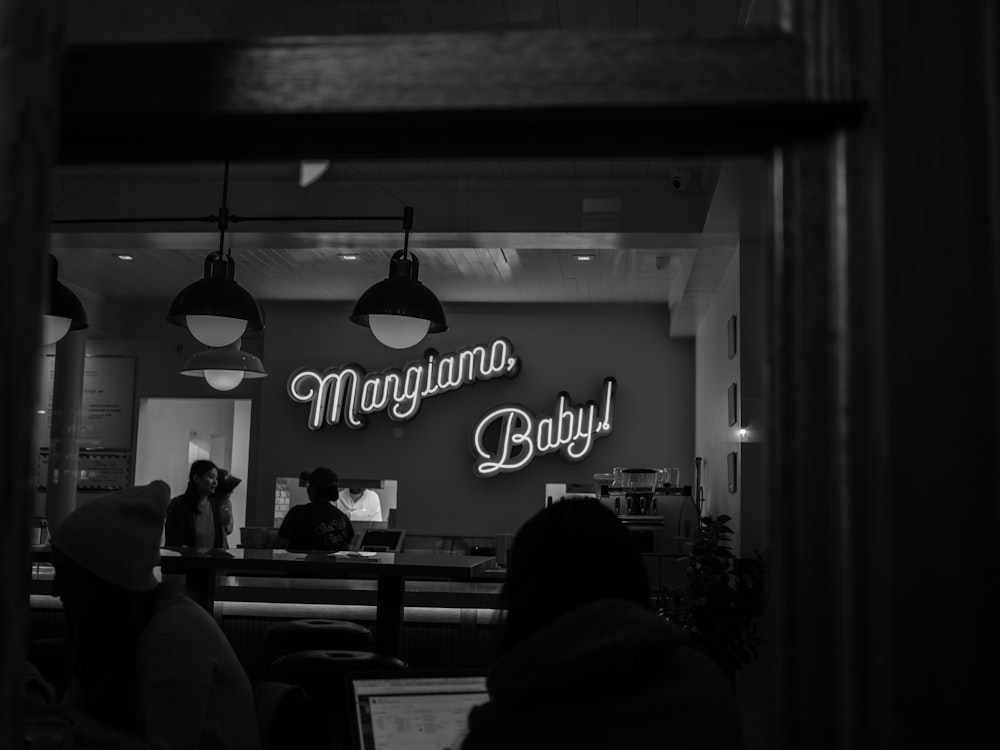 grayscale photography of Margiamo Baby! neon sign