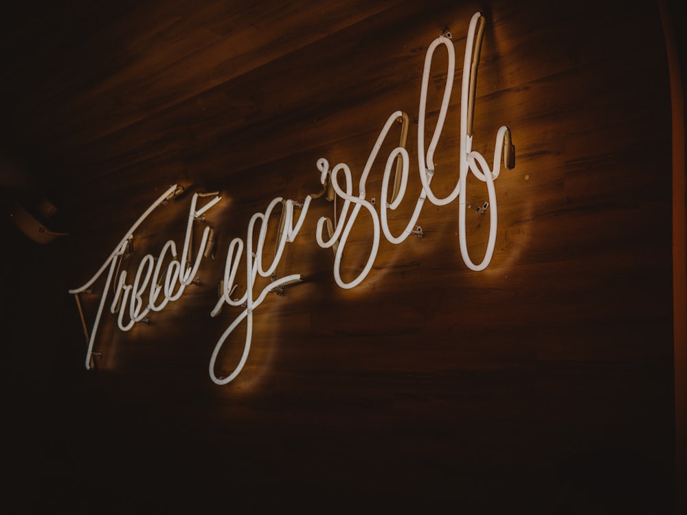 a neon sign on a wooden wall that says,'free yourself '