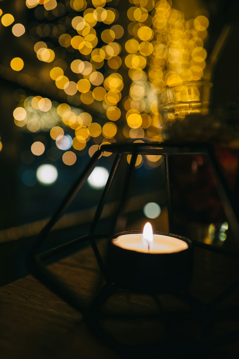 white candle on black candle holder