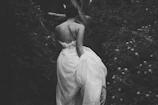 woman wearing gown between flowers
