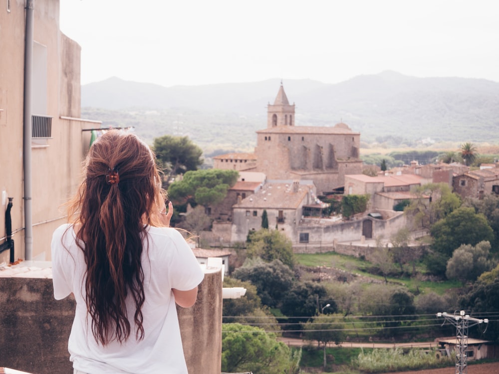 woman standing on terrace facing castle