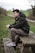 man sitting on brown wooden picnic bench during daytime