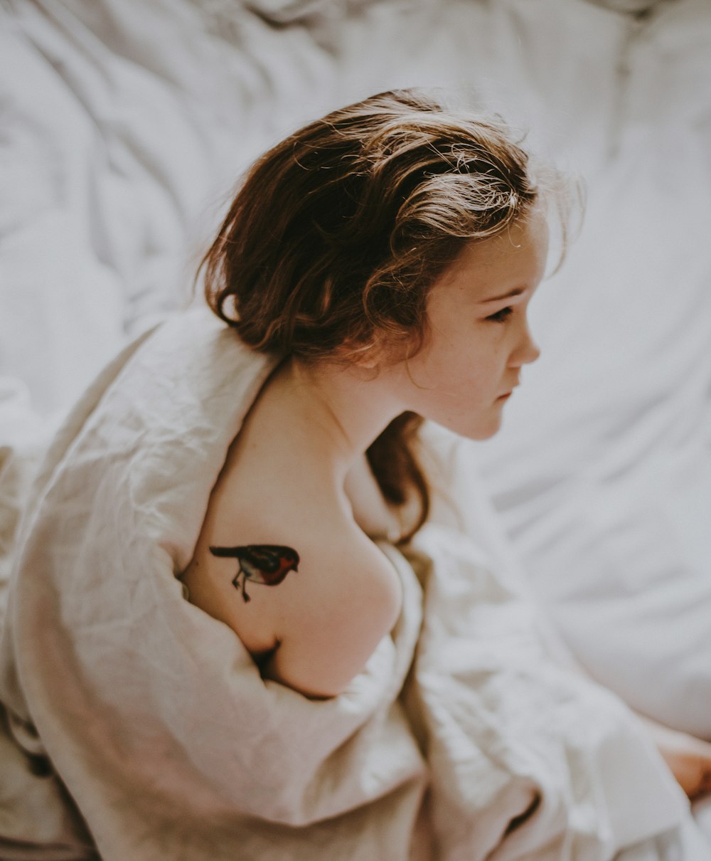 girl sitting on bed