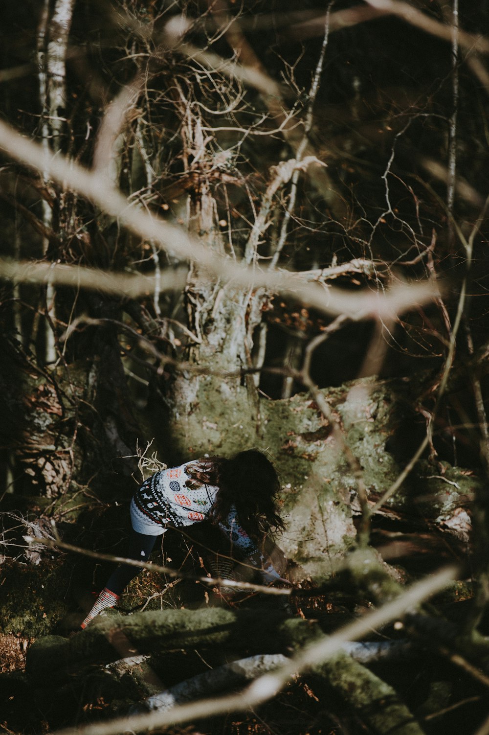 woman through tree vines