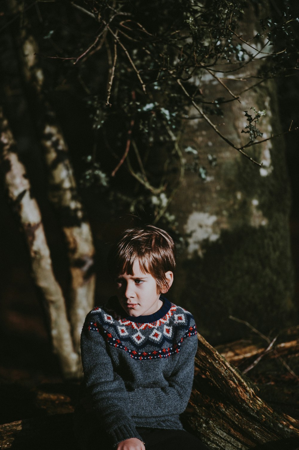 boy wearing multicolored sweater