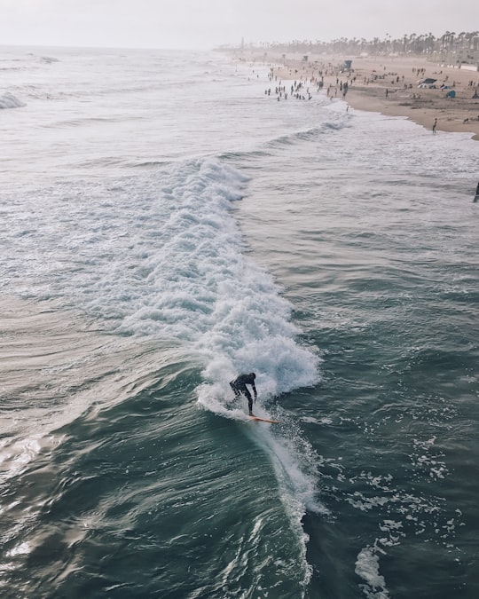 man surfing on the wave in Huntington Beach United States