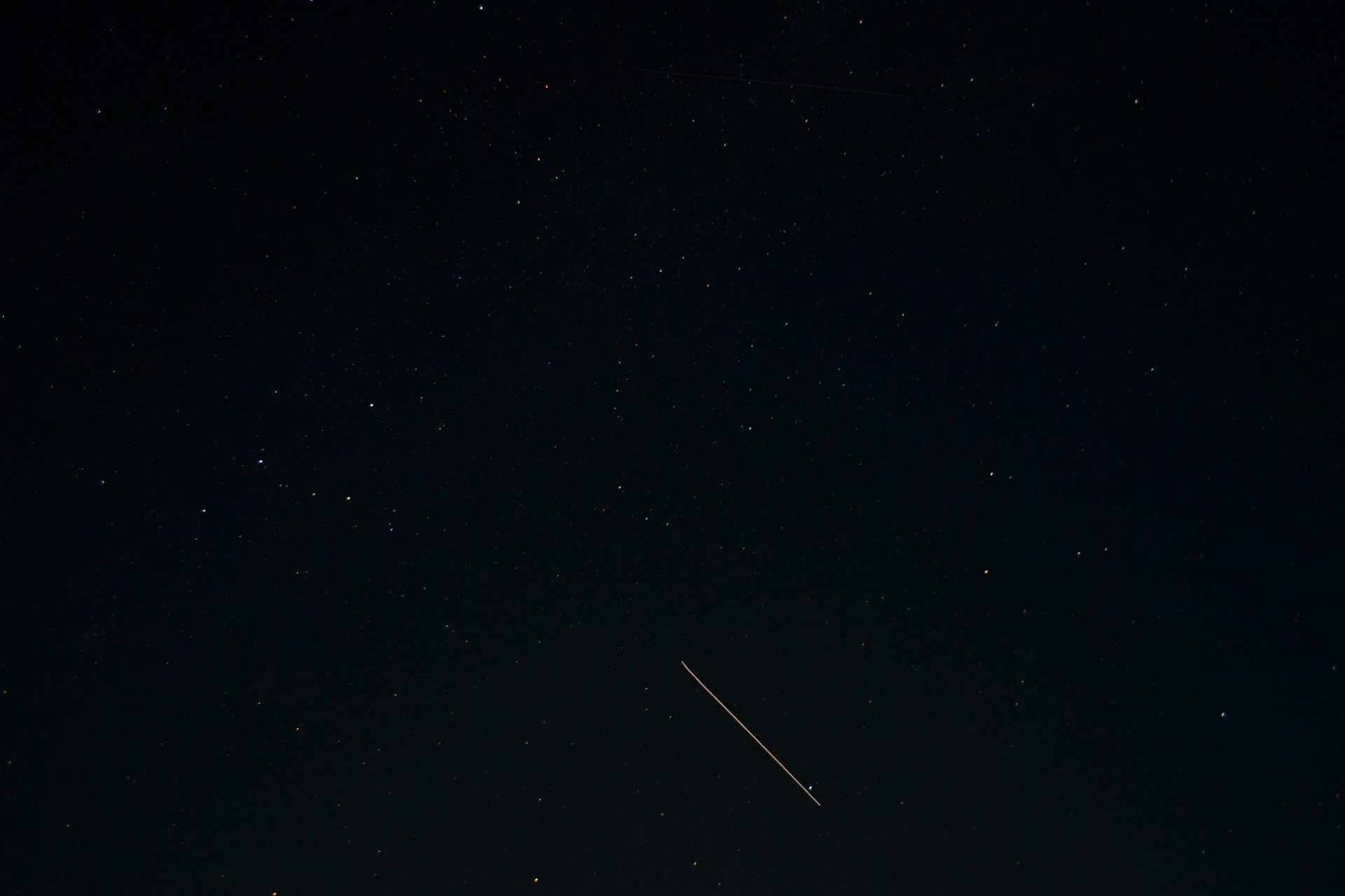 an airplane flying in the sky at night