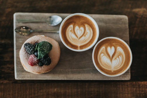 two white ceramic mugs on brown chopping boards