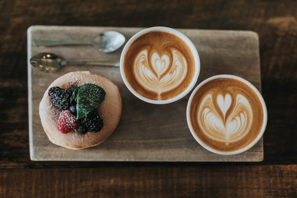 two white ceramic mugs on brown chopping boards