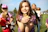 A cheerful child holding fluffy quail chicks outside on a sunny day at the farm.