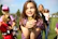 A cheerful child holding fluffy quail chicks outside on a sunny day at the farm.
