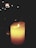 A glowing candle surrounded by soft, ambient lighting.