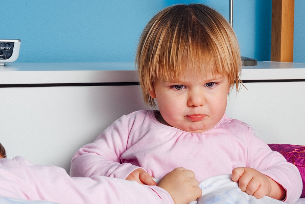 boy wearing pink long-sleeved top