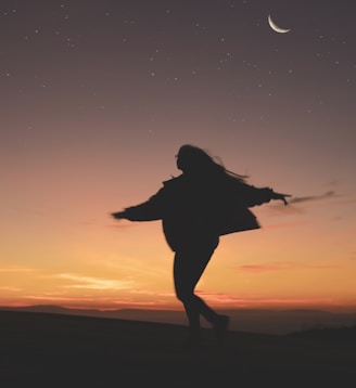 silhouette of woman running during golden hour