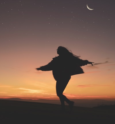 silhouette of woman running during golden hour