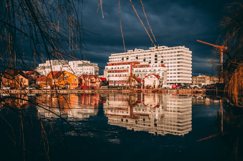 white concrete building near body of water