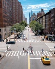 a city street filled with lots of traffic and pedestrians