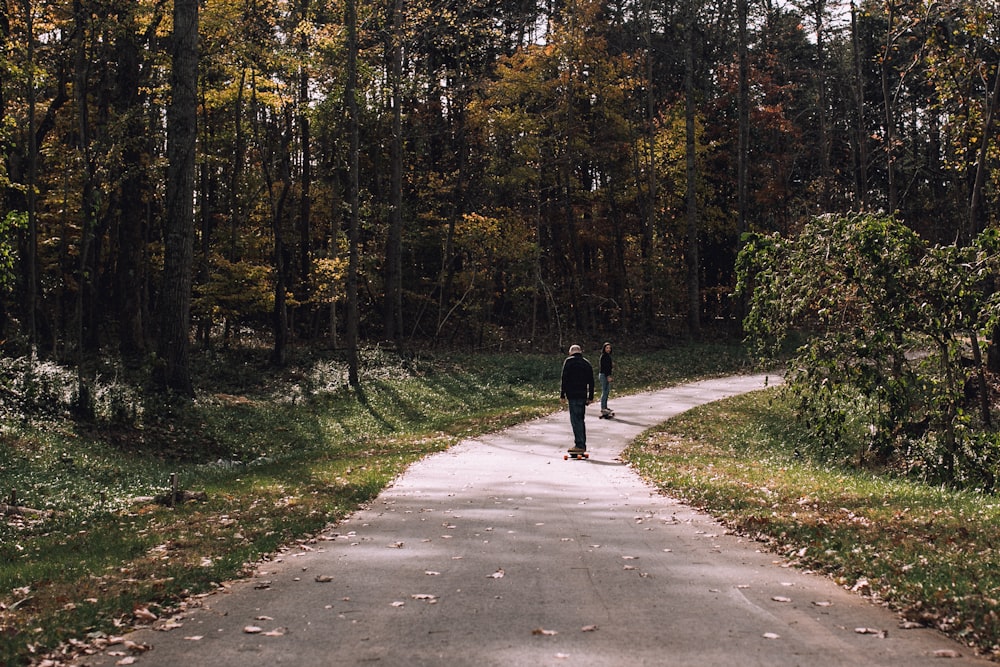 two person looking at each other on pavement road