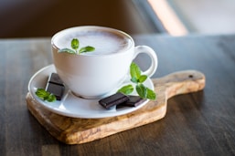 filled teacup with chocolate bars on saucer