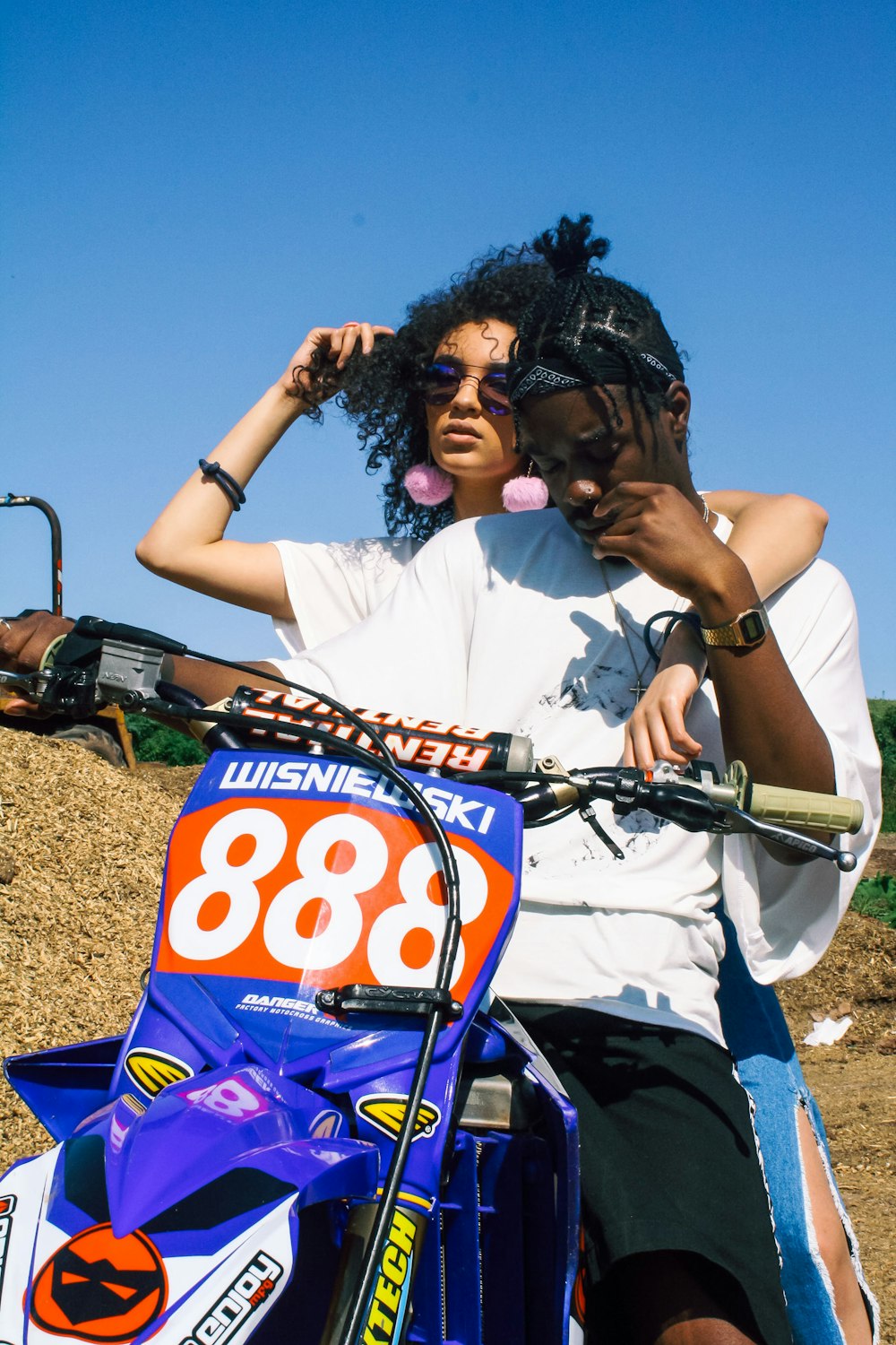 man riding enduro motorcycle with woman