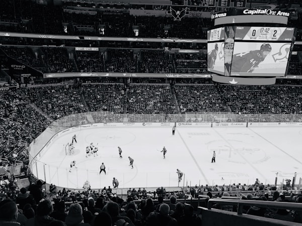 Youth hockey players on the ice inside an arena during a game