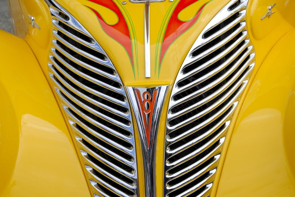 a close up of the front of a yellow car