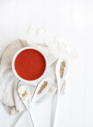 A warm, inviting food shot styled in Scandinavian minimalism with deep crimson accents.