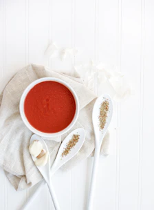 A warm, inviting food shot styled in Scandinavian minimalism with deep crimson accents.
