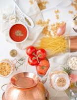 A cheerful kitchen scene with ingredients laid out for a simple pasta dish.