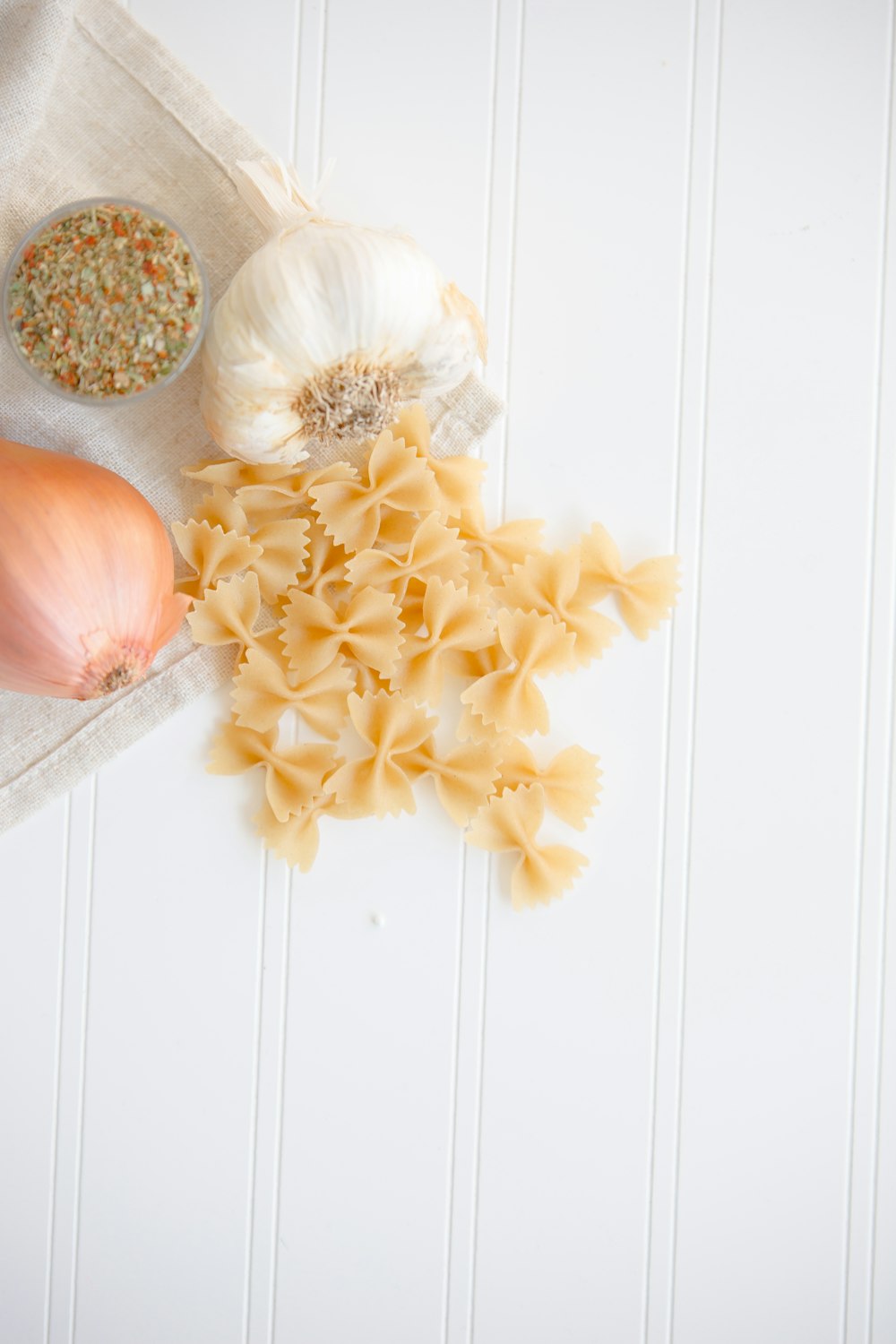 ribbon pasta beside garlic and onion