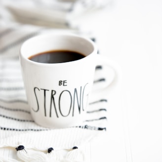 white ceramic mug filled with black coffee