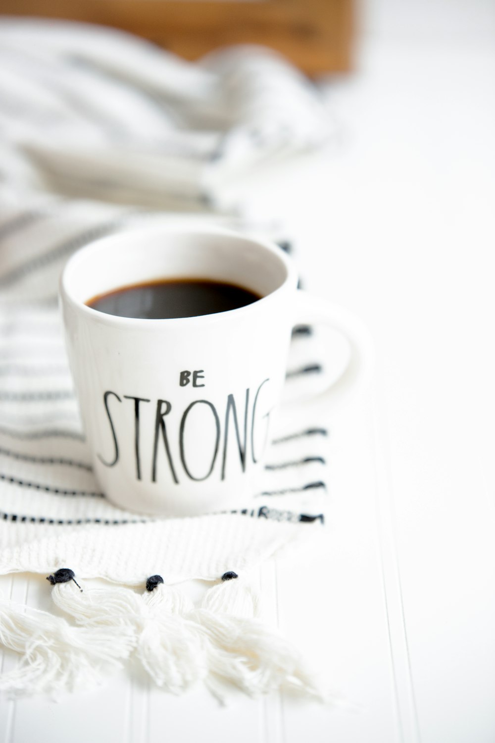 white ceramic mug filled with black coffee