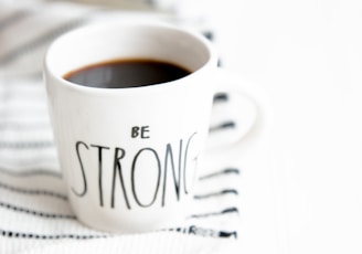 white ceramic mug filled with black coffee