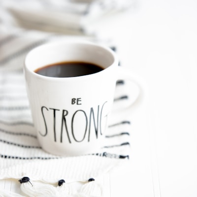 white ceramic mug filled with black coffee