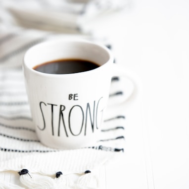 white ceramic mug filled with black coffee