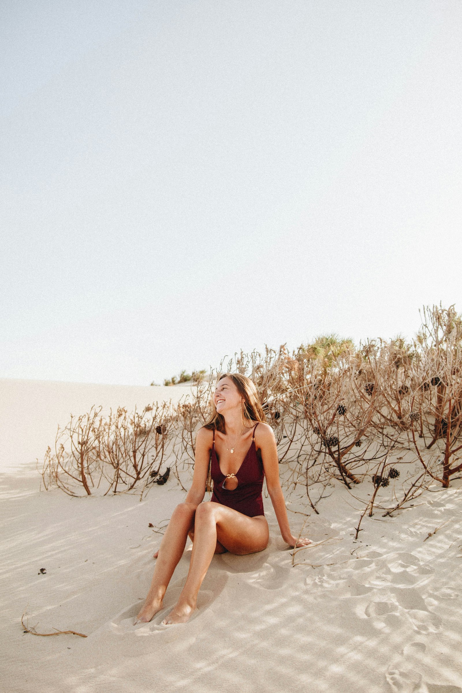 Sigma 18-35mm f/1.8 DC HSM sample photo. Woman sitting on sand photography