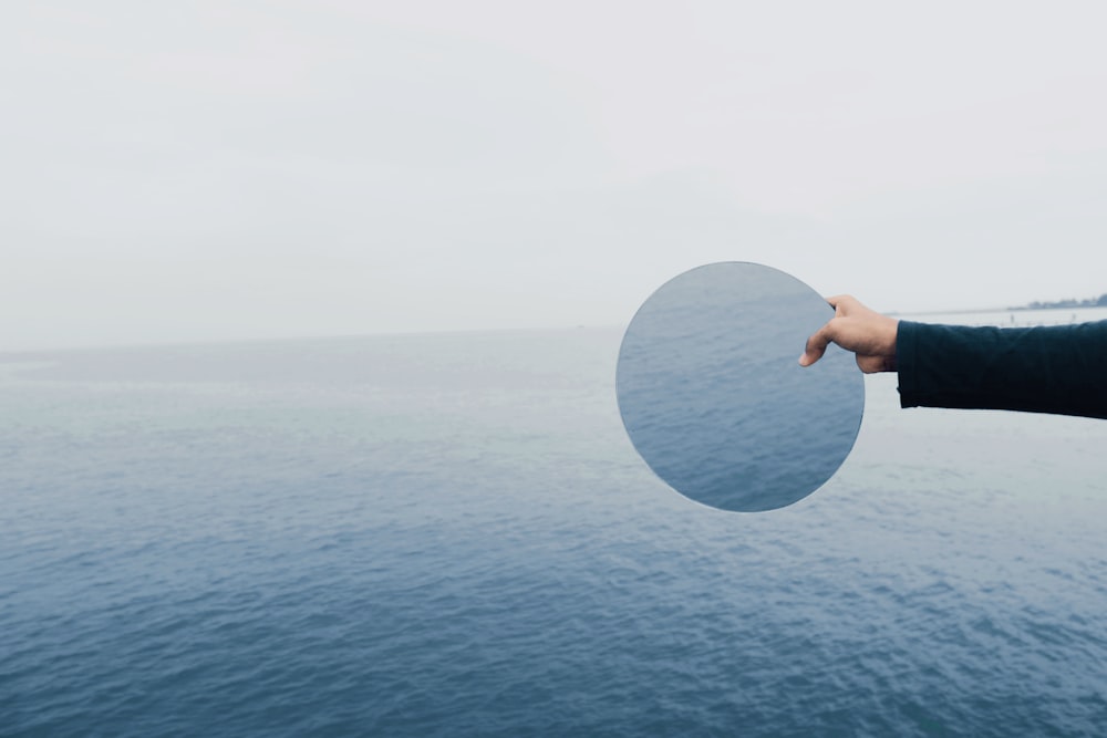 person holding glass top