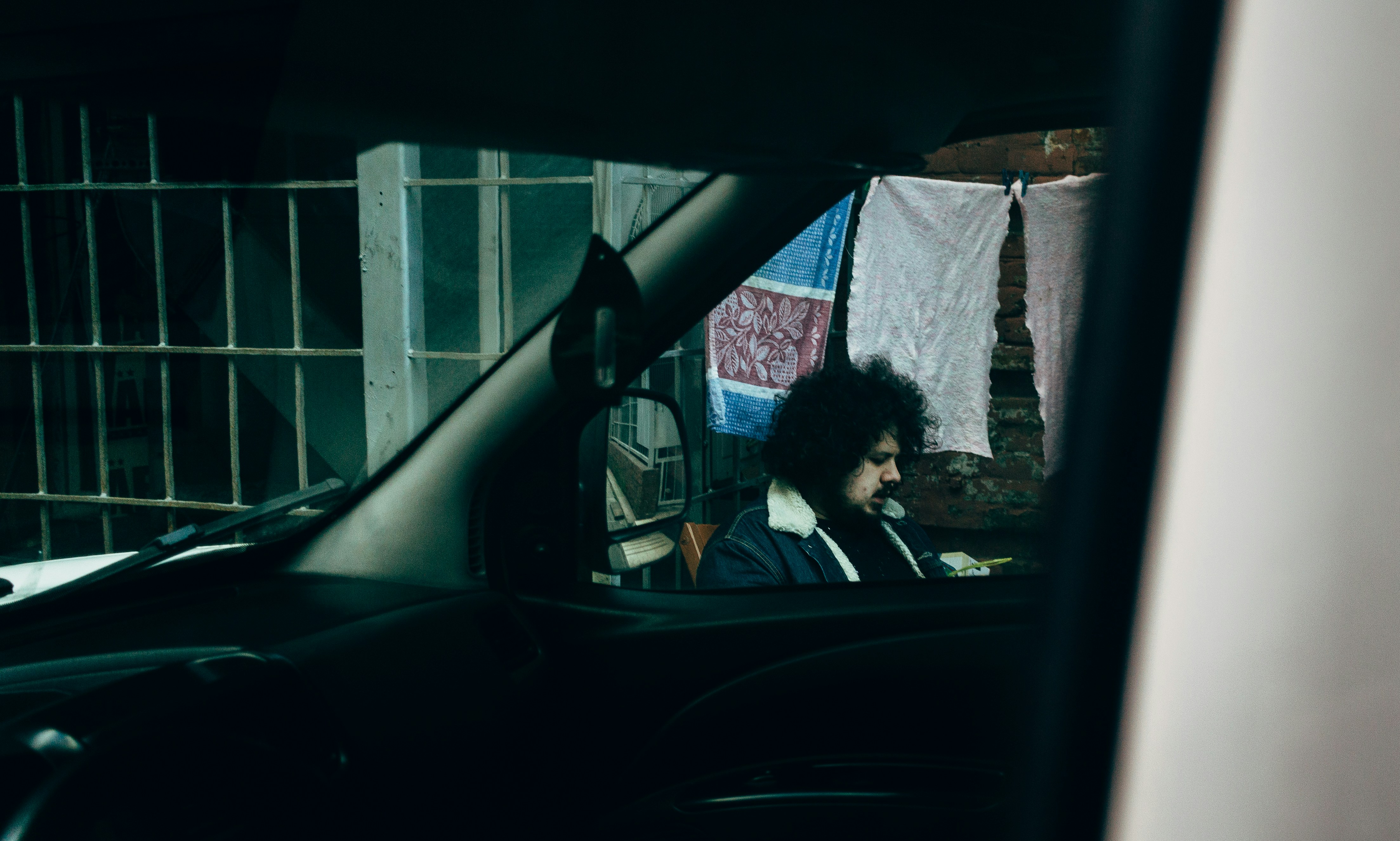 Car windshield displaying man