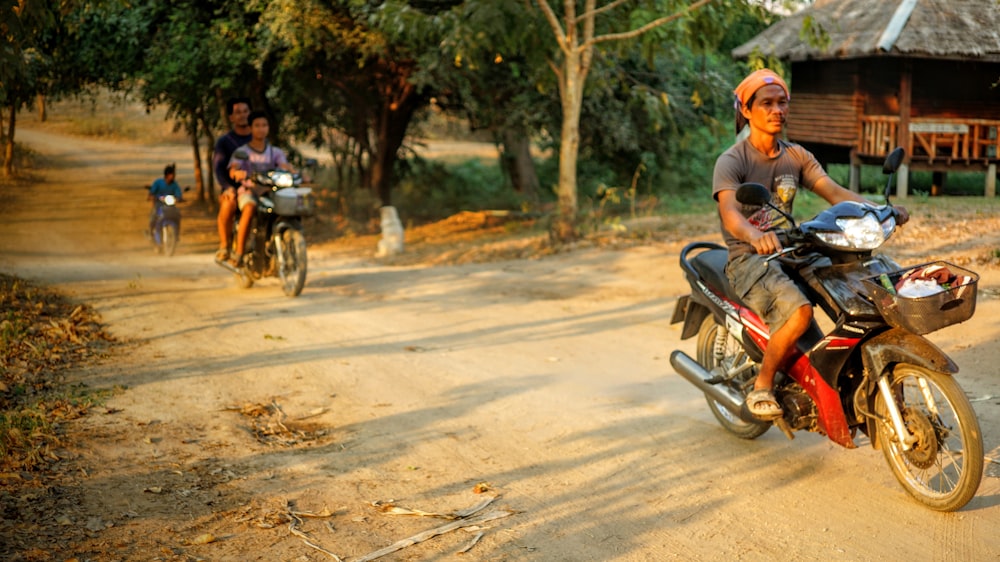 man riding motorcycle passing on road