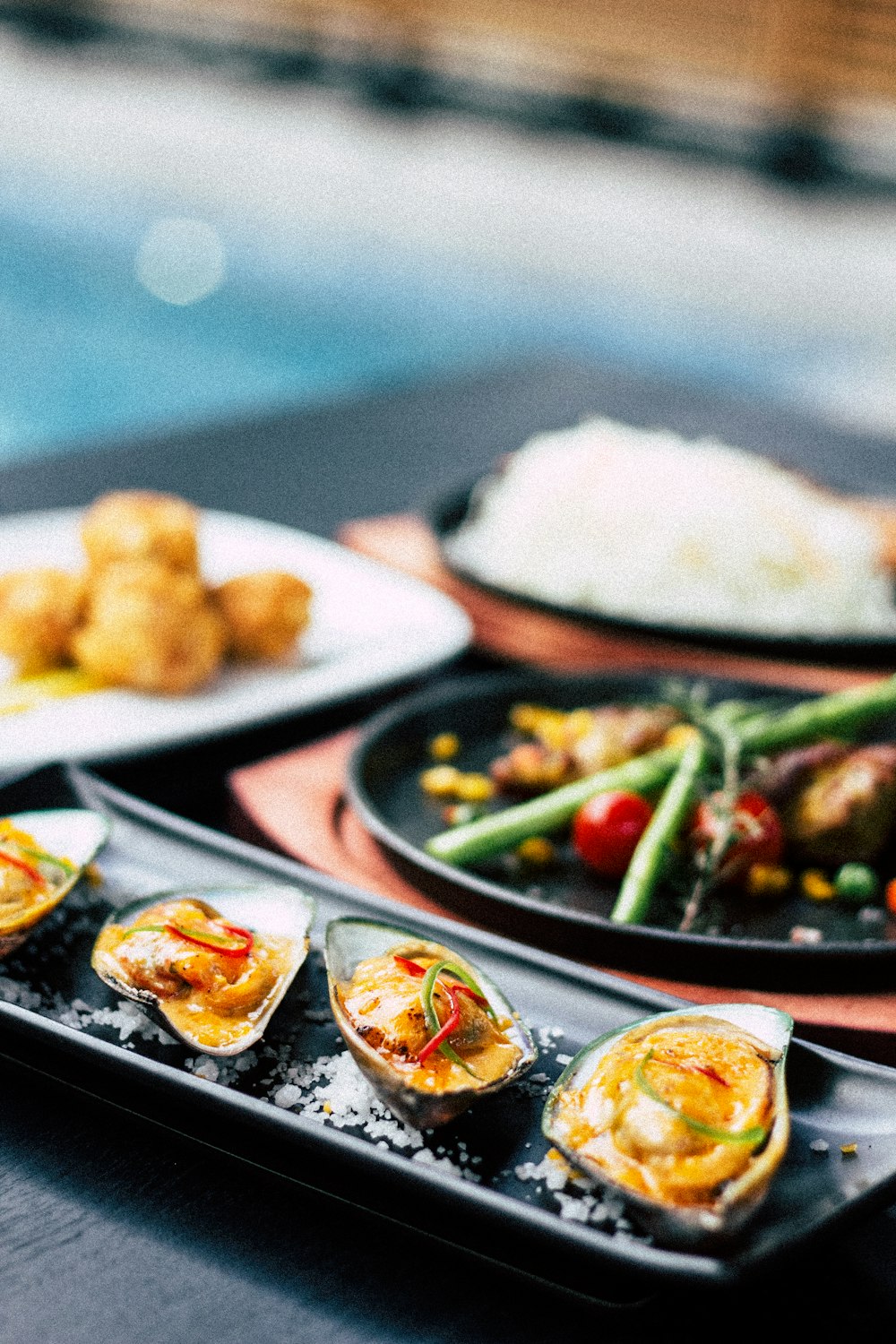 buttered muscles served on black plate