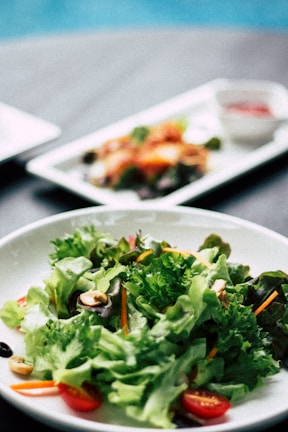 A close-up of hands preparing a healthy salad with fresh ingredients