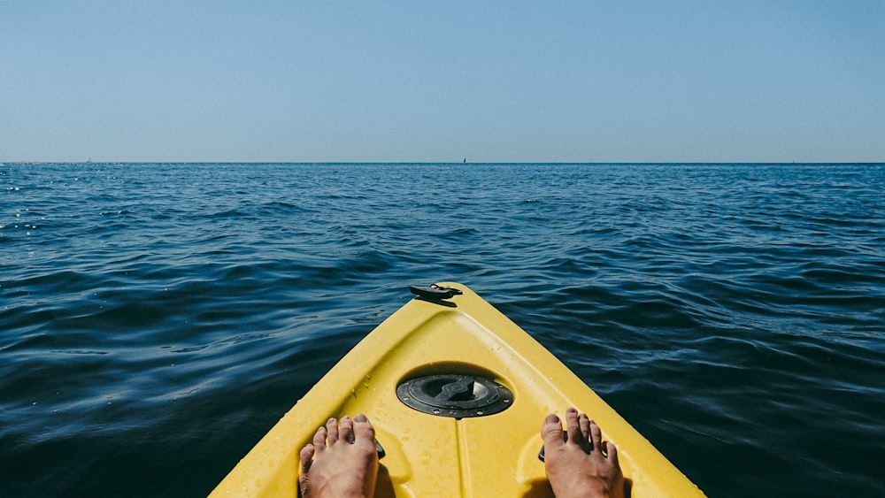 person on boat at the body of water during daytime