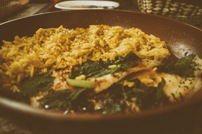 Close-up of a steaming bowl of Thieboudienne, Senegal’s beloved fish and rice dish.