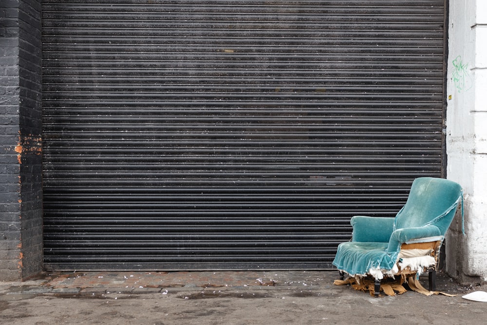 blue tube chair beside door shutter