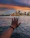 person left hand on body of water