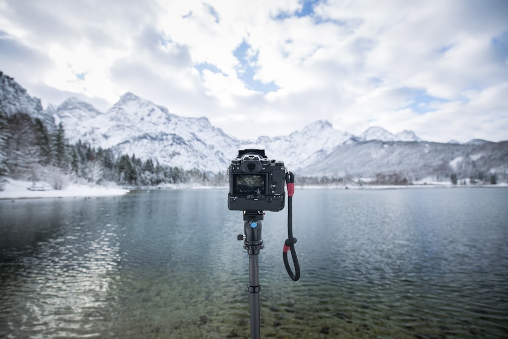 black camera with stand near water