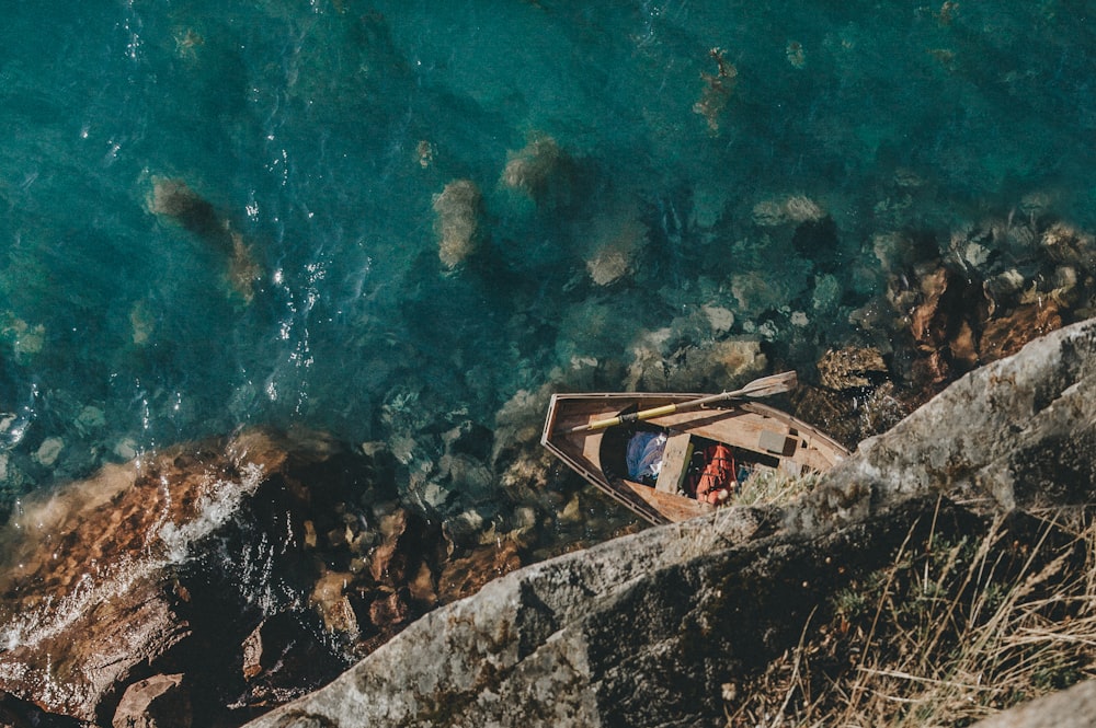 boat on shore with rocks